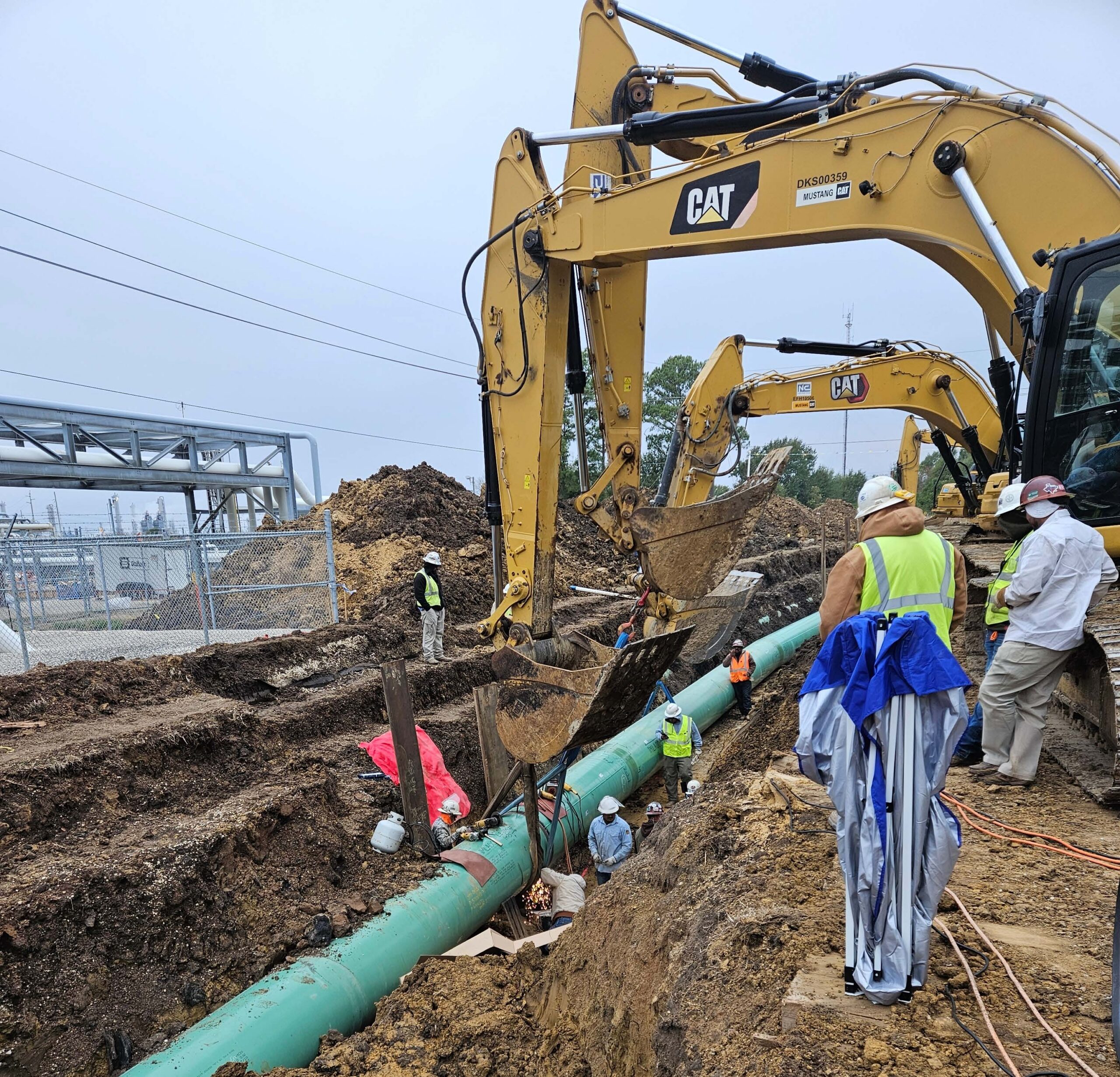 Construction crew working on a buried internally lined steel brine pipeline in Texas